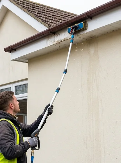 Illustrative brush washing fascia and soffit on a separate cream home