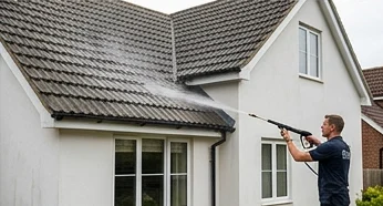 Illustrative controlled biocide application on another white house’s grey roof tiles
