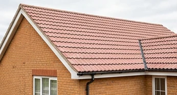 Separate illustrative orange brick home with faded pink mineral roof tiles