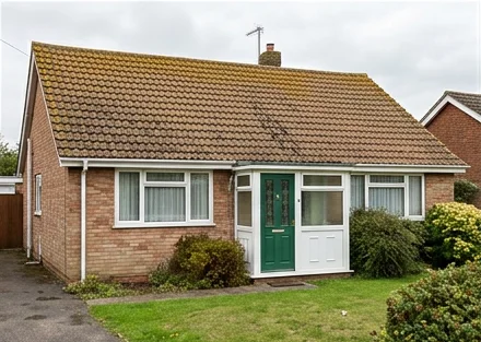 Different illustrative red brick bungalow with a green door and faded ochre mineral roof tiles