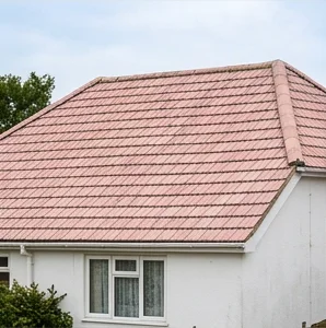 Separate illustrative white house with faded pale pink mineral roof tiles