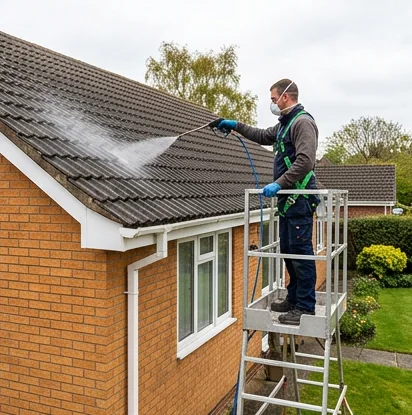 Illustrative biocide application to an orange brick bungalow roof from a platform