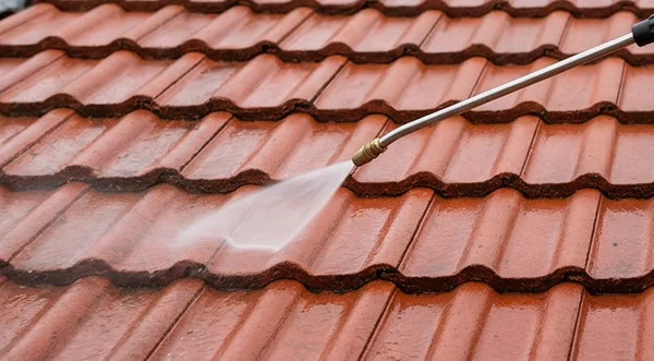Gentle treatment spray applied to red concrete tiles